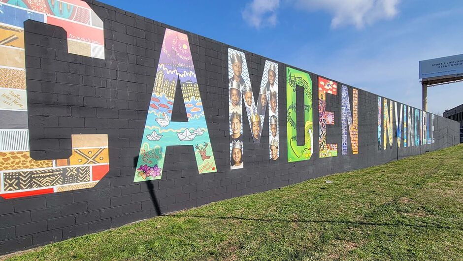 A large colorful mural that reads, "Camden Invincible"