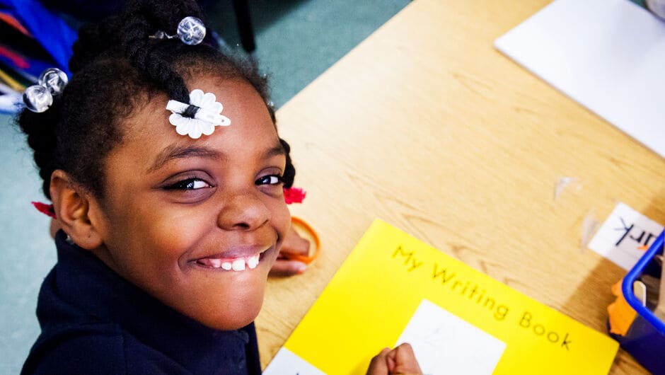 Alt text: A student and her writing book