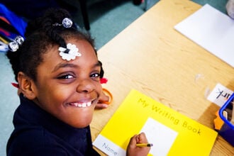 Alt text: A student and her writing book