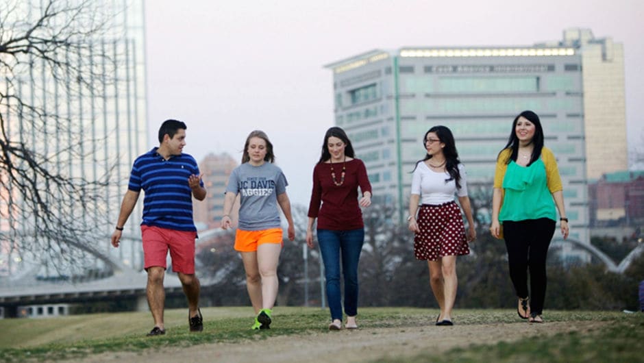 A group of Teach For America alums walking through a park.