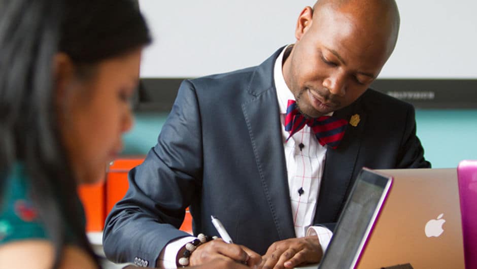 TFA alum Jubria Lewis takes notes during a meeting.