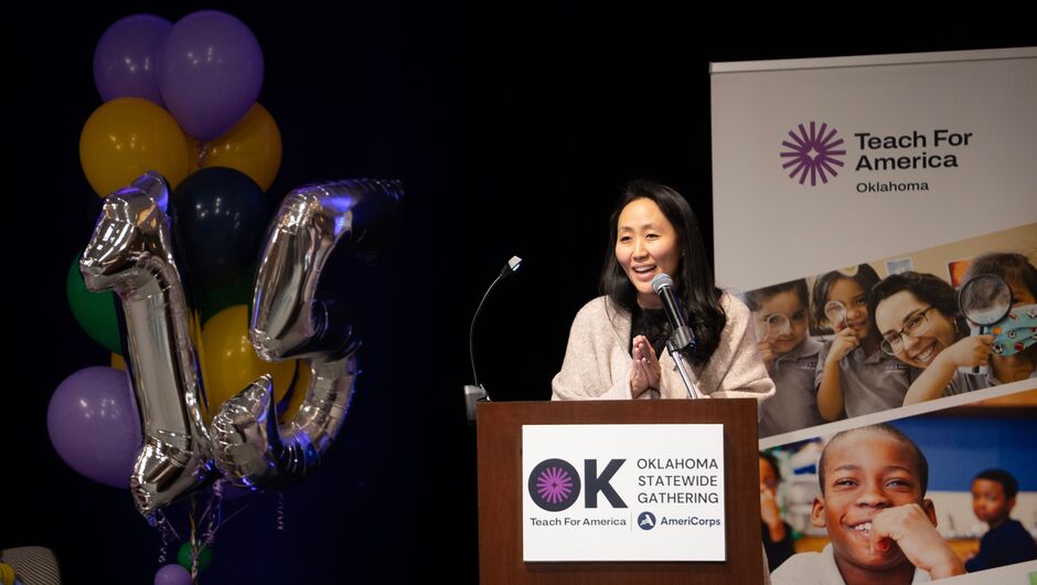 A woman speaking at a podium.