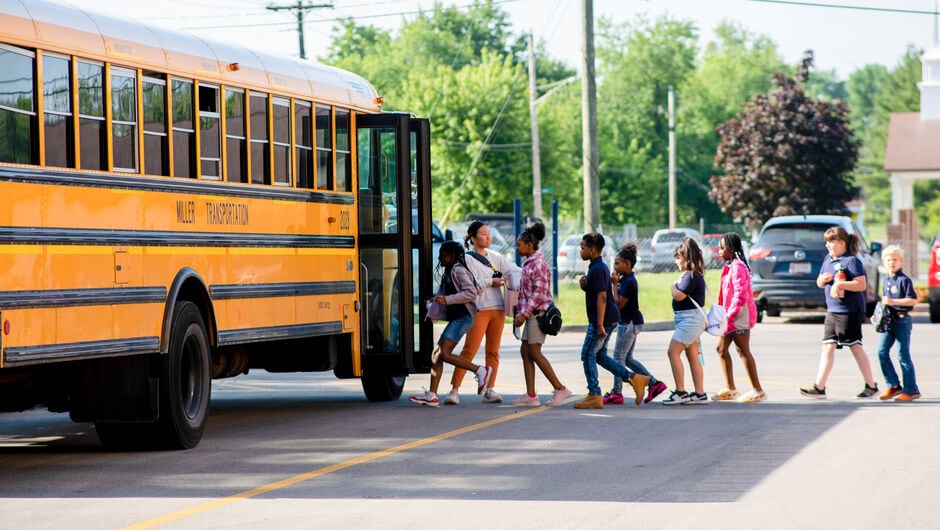 children walking toward school bus