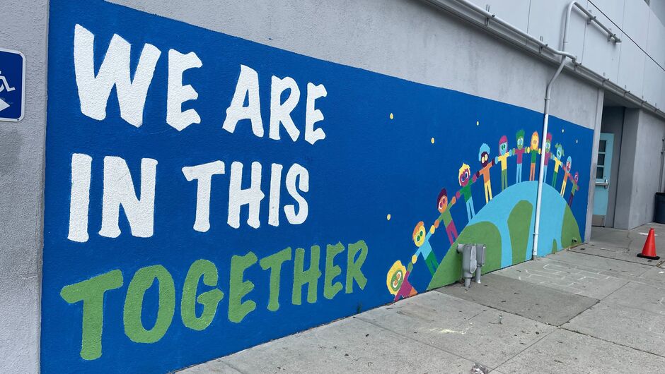 A mural that says, "We are in this together."