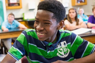 Alt text: A student at his desk