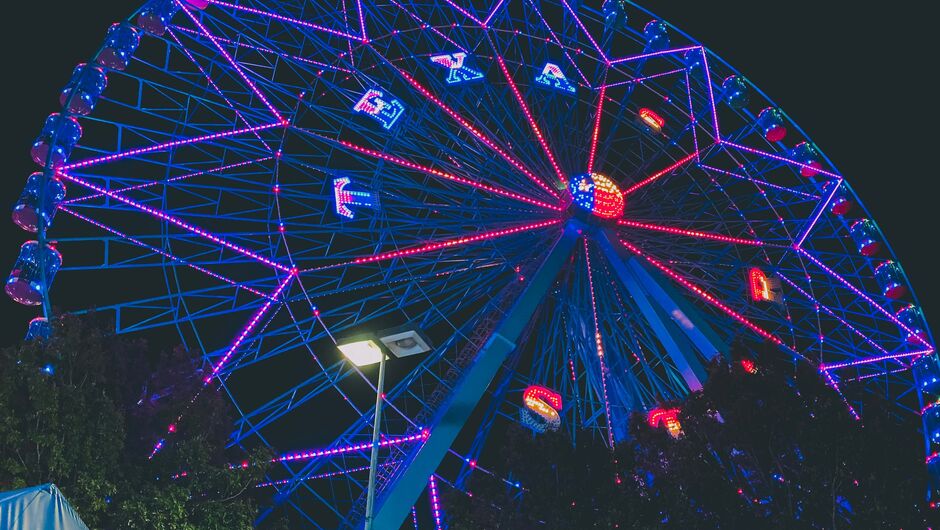 A ferris wheel is lit up with the word Texas.