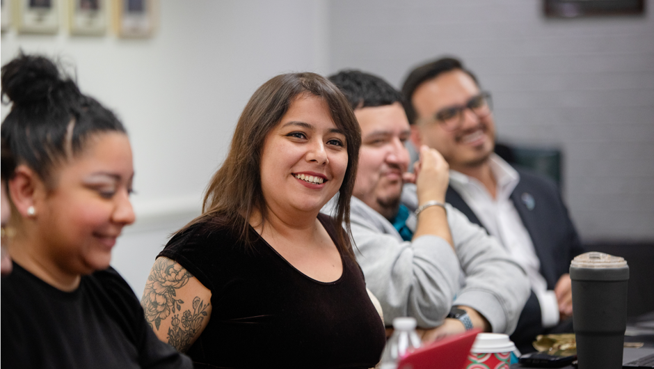Adults seated in a conference room.