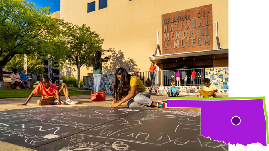 Students draw on the ground with chalk outside an Oklahoma City museum.